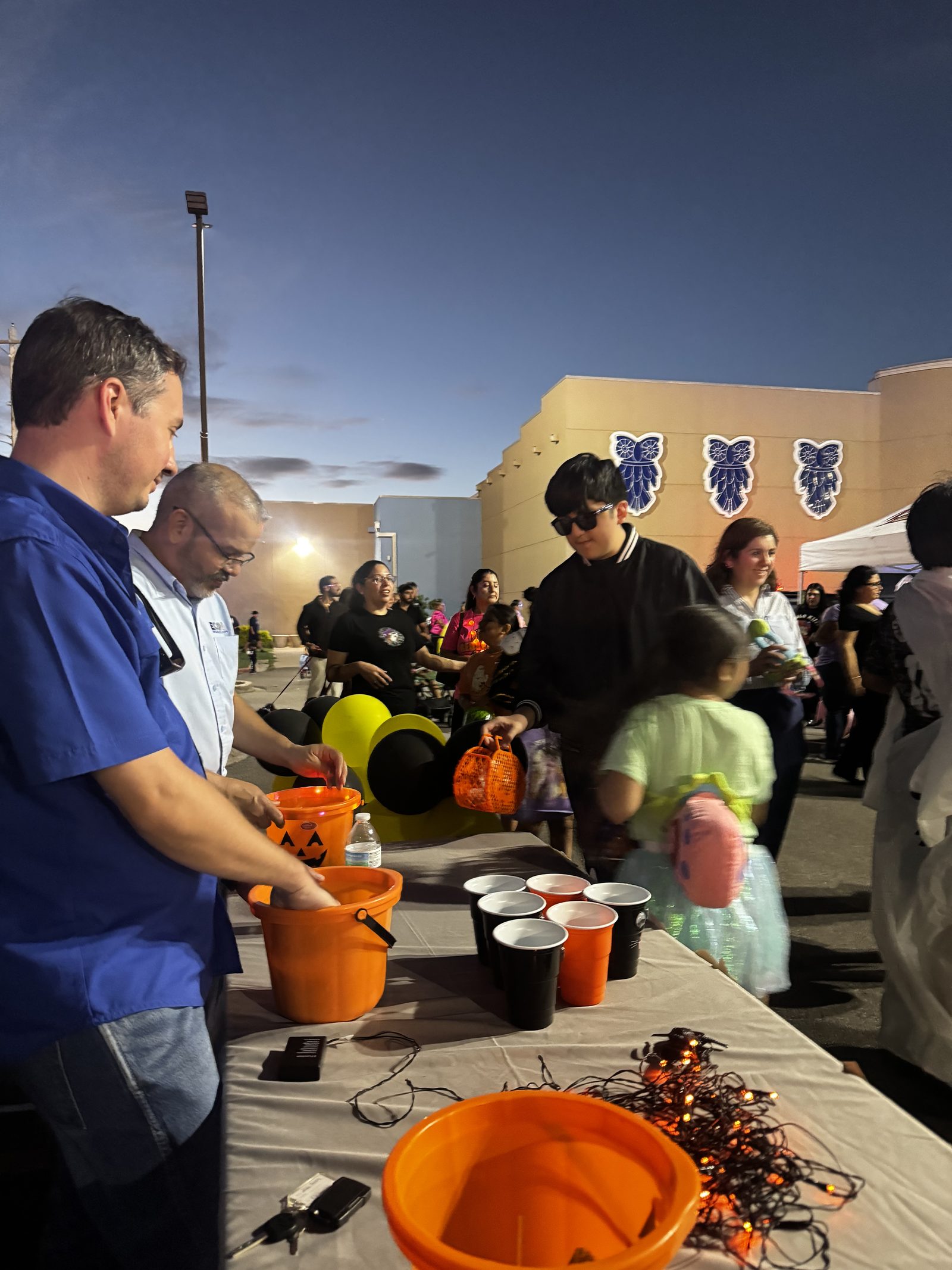 E-CON Group team handing out candy to families at the Rio Grande Valley College Trunk or Treat in Pharr, TX